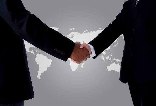 Business with people shaking hands with a global background Business with people shaking hands with a global background